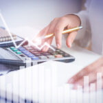 Accountant calculating profit with financial analysis graphs - Güncel Group